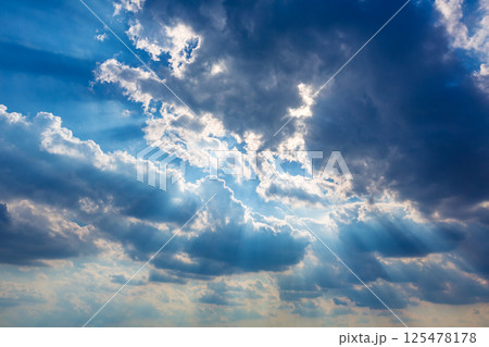 Dramatic cloudy sky clouds with real sun beams 125478178