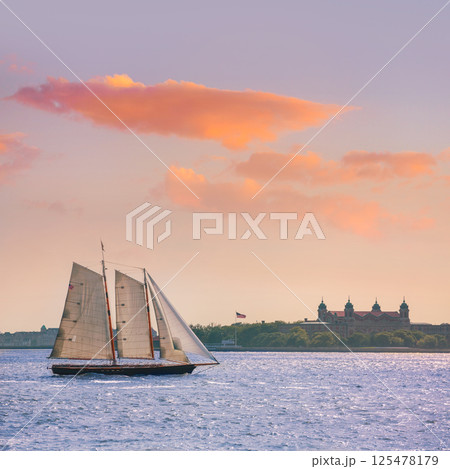New York sailboat sunset and Ellis Island New York sailboat sunset and Ellis Island 125478179