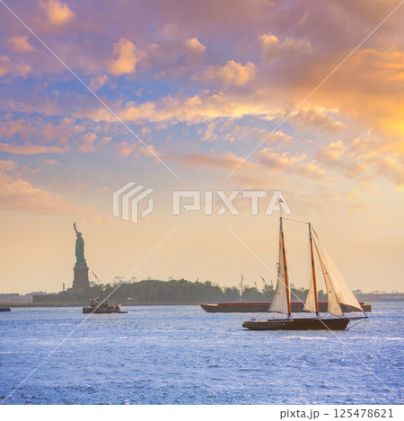 New York sailboat sunset and Statue of Liberty 125478621