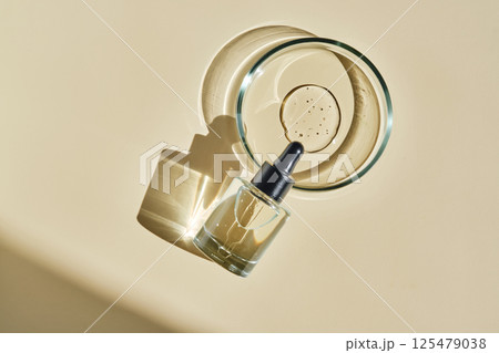Facial serum with texture in a petri dish. 125479038