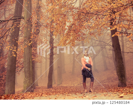 Fashion blonde woman with jacket in autumn park. 125480184