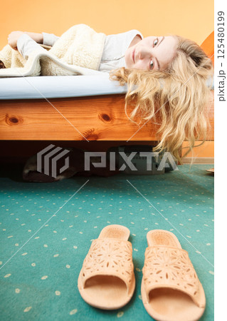 Woman waking up in bed in morning after sleeping Woman waking up in bed in morning after sleeping 125480199