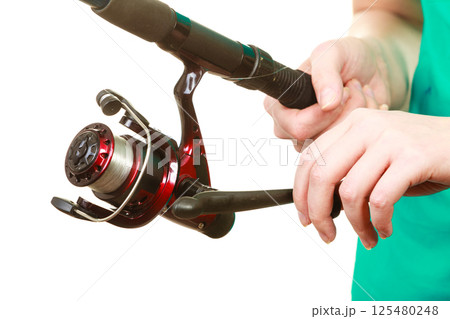 Person holding fishing rod, spinning equipment. 125480248
