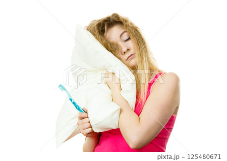 Sleepy woman hugging white pillow Sleepy woman hugging white pillow 125480671