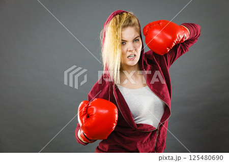 Woman wearing boxing gloves Woman wearing boxing gloves 125480690
