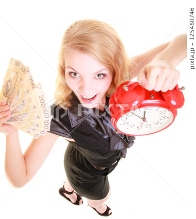 Woman holding polish money banknote and alarm clock. Woman holding polish money banknote and alarm clock. 125480746