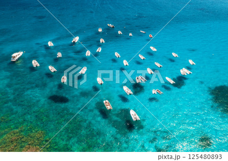 Aerial view of many motorboats on blue sea at sunset in summer 125480893
