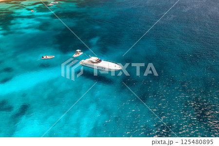 Aerial view of luxury yacht and boat in blue sea in summer 125480895