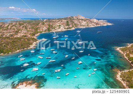 Aerial view of luxury yachts and boats on blue sea, island Aerial view of luxury yachts and boats on blue sea, island 125480901