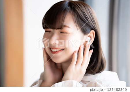 音楽を聴く若い女性 125482849