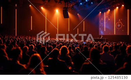 Attendees in a theater captivated by a business technology presentation at a bustling conference event 125485130