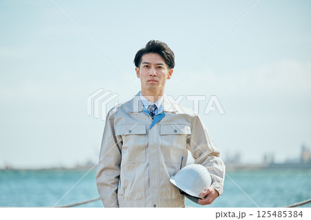 作業着姿の20代の若い男性 125485384