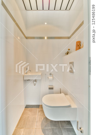 A sleek, modern bathroom featuring minimalist design elements, clean lines, and a bright, airy atmosphere, perfect for relaxation and comfort. 125486199