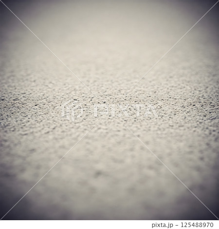 A textured light gray surface fills the frame with a shallow depth of field 125488970