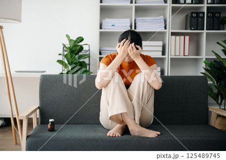 Asian woman sit Depression Dark haired pensive glance Standing by window and anxiety Copy space. Asian woman sit Depression Dark haired pensive glance Standing by window and anxiety Copy space. 125489745