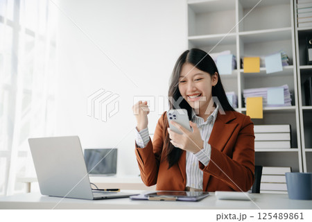 Asian business woman are delighted and happy with the work they do on their tablet, laptop and taking notes at office. Asian business woman are delighted and happy with the work they do on their tablet, laptop and taking notes at office. 125489861
