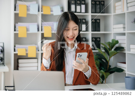 Asian business woman are delighted and happy with the work they do on their tablet, laptop and taking notes at office. Asian business woman are delighted and happy with the work they do on their tablet, laptop and taking notes at office. 125489862