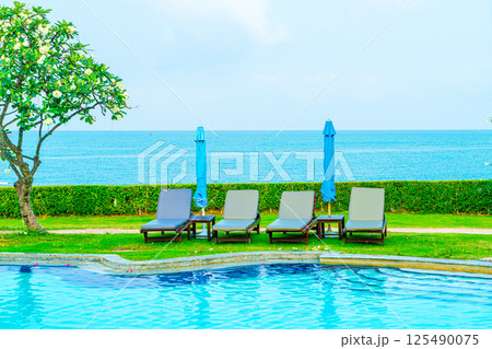 chair pool and umbrella around swimming pool chair pool and umbrella around swimming pool 125490075