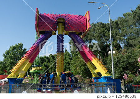 Bright colorful carousel in a summer amusement park. Bright colorful carousel in a summer amusement park. 125490639