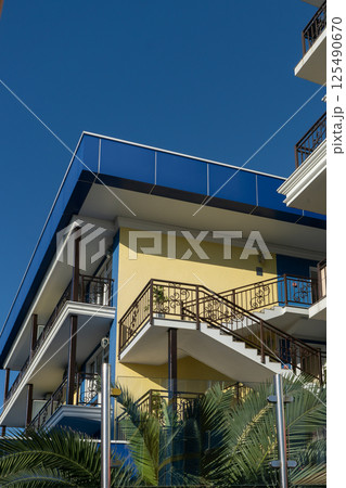 Summer hotel building with a hamlet on the facade. 125490670