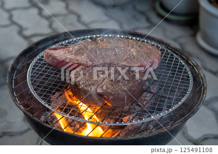 Meat on the charcoal grill 125491108