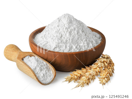 wheat flour in wooden bowl and scoop with ears near isolated on white background wheat flour in wooden bowl and scoop with ears near isolated on white background 125491246
