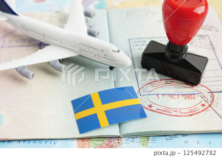 Sweden flag and passport with airplane for travel. Sweden flag and passport with airplane for travel. 125492782