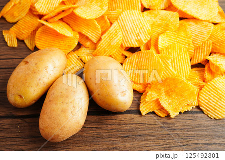 Potato chips , delicious BBQ seasoning spicy for crips, thin slice deep fried snack fast food. 125492801
