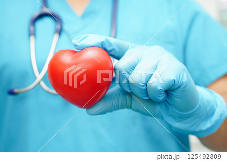 Asian woman doctor holding red heart for health in hospital. Asian woman doctor holding red heart for health in hospital. 125492809
