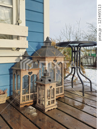 Retro lanterns on a wooden floor, vertical view. 125495513