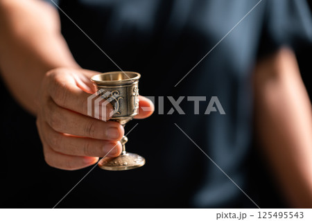 Sacred ceremony of Communion, Christians express their faith by partaking in holy bread, deepening their spiritual connection with God within the church. communion, religion, christian, faith, holy. Sacred ceremony of Communion, Christians express their faith by partaking in holy bread, deepening their spiritual connection with God within the church. communion, religion, christian, faith, holy. 125495543