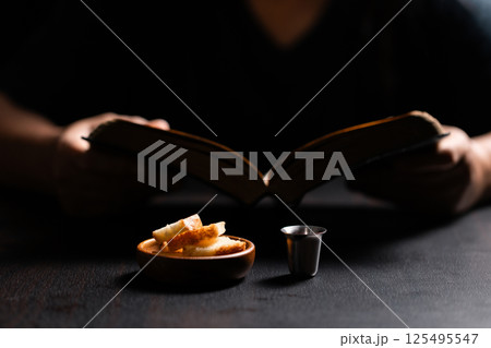 Sacred ceremony of Communion, Christians express their faith by partaking in holy bread, deepening their spiritual connection with God within the church. communion, religion, christian, faith, holy. 125495547