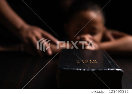 A mother teaches her child about Jesus Christ and the Christian faith, reading the Bible together and nurturing his belief in God. child, jesus christ, bible, christian, mother, person, faith, boy. A mother teaches her child about Jesus Christ and the Christian faith, reading the Bible together and nurturing his belief in God. child, jesus christ, bible, christian, mother, person, faith, boy. 125495552