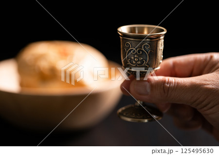 Sacred ceremony of Communion, Christians express their faith by partaking in holy bread, deepening their spiritual connection with God within the church. communion, religion, christian, faith, holy. Sacred ceremony of Communion, Christians express their faith by partaking in holy bread, deepening their spiritual connection with God within the church. communion, religion, christian, faith, holy. 125495630