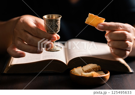 Sacred ceremony of Communion, Christians express their faith by partaking in holy bread, deepening their spiritual connection with God within the church. communion, religion, christian, faith, holy. Sacred ceremony of Communion, Christians express their faith by partaking in holy bread, deepening their spiritual connection with God within the church. communion, religion, christian, faith, holy. 125495633