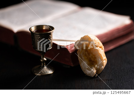 Communion, Christians celebrate their faith by partaking in bread and wine, symbolizing the body and blood of Jesus Christ, as taught in the Bible and cherished in their holy religion. communion, holy 125495667