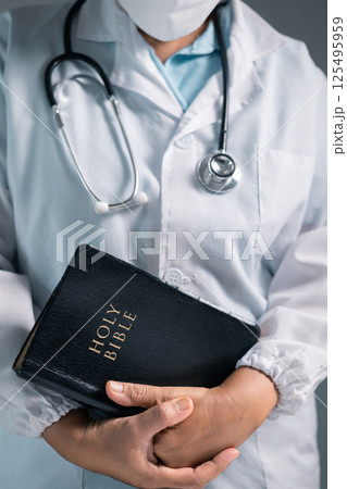 Doctor clasped their hands in prayer, hoping for the best as they provided medical care in hospital clinic. doctor, pray, medicine, health, medical, hand, hospital, care, clinic, hope, prayer, person. 125495959