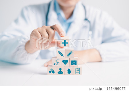 Doctor explains concept of disease management and insurance coverage to person, highlighting importance of medicine and care within business of hospital services. disease, medicine, block, insurance. 125496075