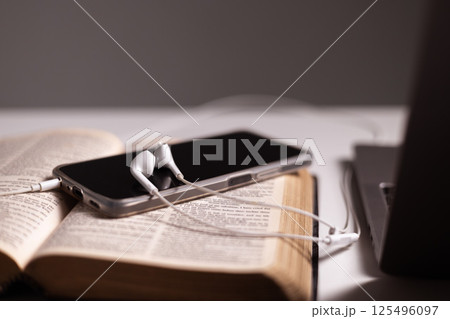 Through online platforms, Christians strengthen their faith in God by praying and reading the Bible, embracing technology to deepen their connection with Jesus Christ and their religion. jesus christ 125496097