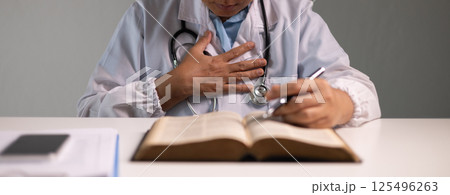 Doctor prays for the health of the person under their care, as medicine, nurses, and health care at the hospital work together to fight the disease. doctor, pray, health, person, medicine, care. 125496263