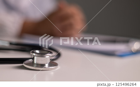 Doctor prays for the health of the person under their care, as medicine, nurses, and health care at the hospital work together to fight the disease. doctor, pray, health, person, medicine, care. 125496264