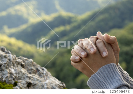 Woman praying and worshiping God on the mountain for a good life. 125496478