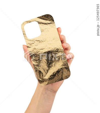 Golden metallic phone case with a crumpled, shiny texture, held by hand. Stylish, elegant design 125497365