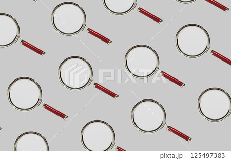 Magnifying glass lenses arranged in a repeating pattern, perfect for investigation, research, and Magnifying glass lenses arranged in a repeating pattern, perfect for investigation, research, and 125497383
