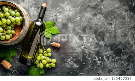 Bottle of wine is on a table with a bunch of grapes and a cork 125497557