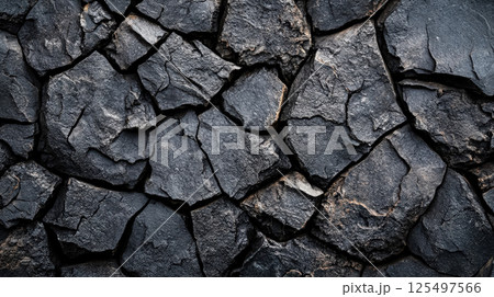 Close up of a rock wall with many cracks and holes 125497566