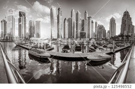 Skyscrapers and bridge over water, black and white style, city background, Dubai Marina bay UAE Skyscrapers and bridge over water, black and white style, city background, Dubai Marina bay UAE 125498552