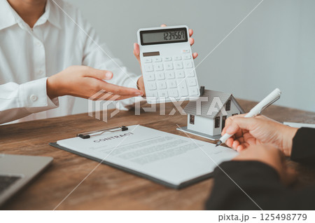 Salesperson Holding house keys concept, house keys for new house, new house purchase. Salesperson Holding house keys concept, house keys for new house, new house purchase. 125498779