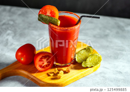 Bloody Mary cocktail in glass served with tomatoes and pickles on grey stoned surface. Red cocktail. Alternative taste. Dirty dump drink Bloody Mary cocktail in glass served with tomatoes and pickles on grey stoned surface. Red cocktail. Alternative taste. Dirty dump drink 125499885