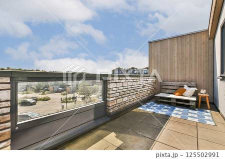 A contemporary rooftop terrace featuring stylish furniture and a scenic view, perfect for relaxation and social gatherings with a blend of comfort and aesthetics. A contemporary rooftop terrace featuring stylish furniture and a scenic view, perfect for relaxation and social gatherings with a blend of comfort and aesthetics. 125502991